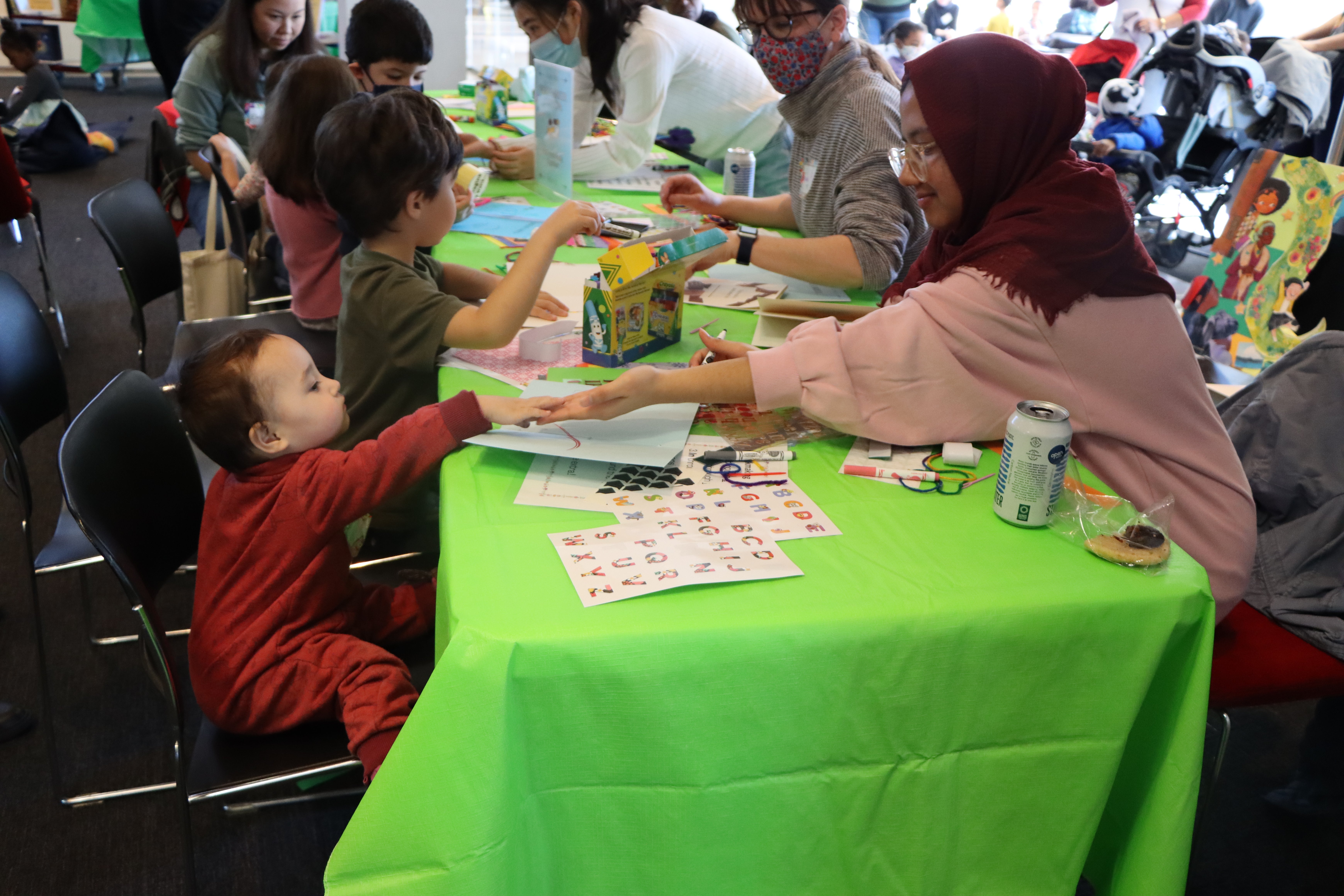 Children/students participate in activities hosted by staff and volunteers at a community literacy event